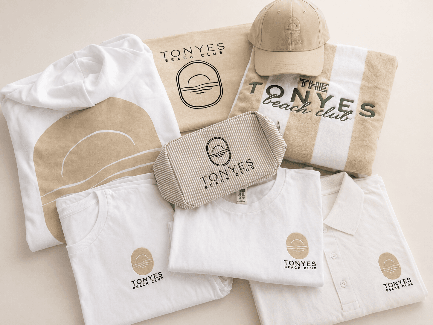Embroidered apparel, towels, cap, and pouch arranged for a coordinated business event